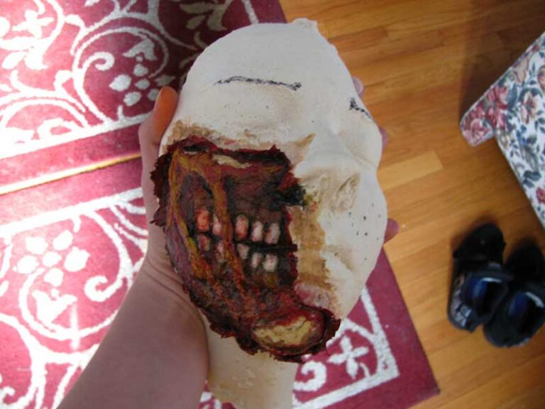 The painted prosthetic appliance, made to look like the flesh has been torn away to reveal the jaw and teeth underneath.