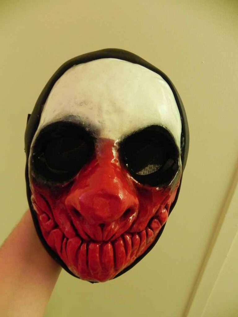 The finished mask, viewed from the front to see the black mesh covering the eye sockets.