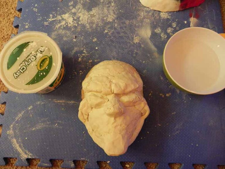 Sculpting the shape of the mask out of air-dry clay.