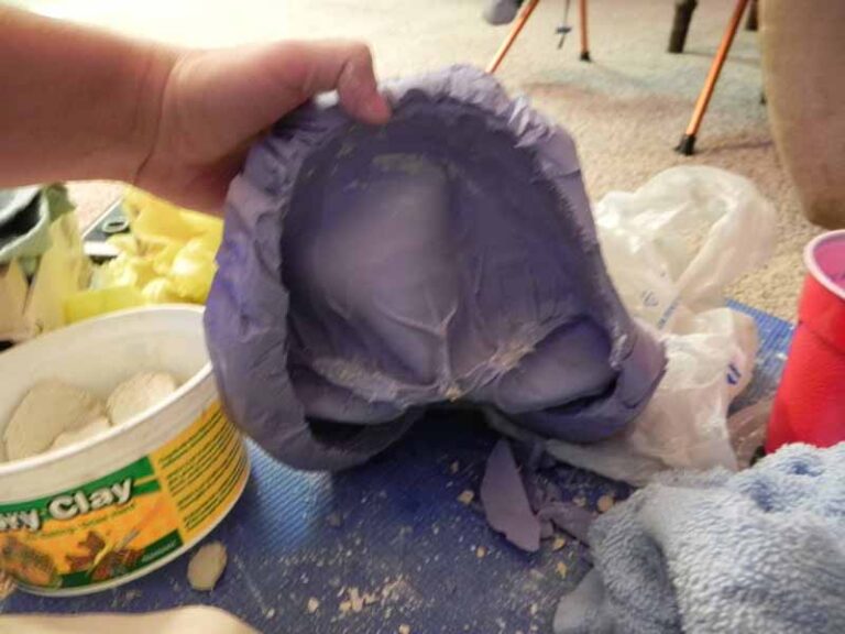Peeling the silicone mold and cleaning out clay from the crevices.