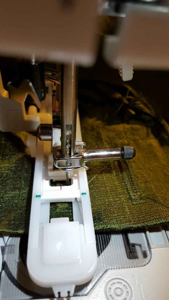 Close-up of button holes being sewn into the jacket.