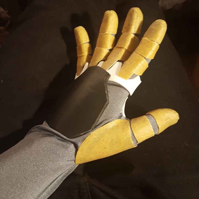 Work in progress of the robotic hand, each finger piece cut and shaped from thermoplastic and attached to a silver sleeve/glove.
