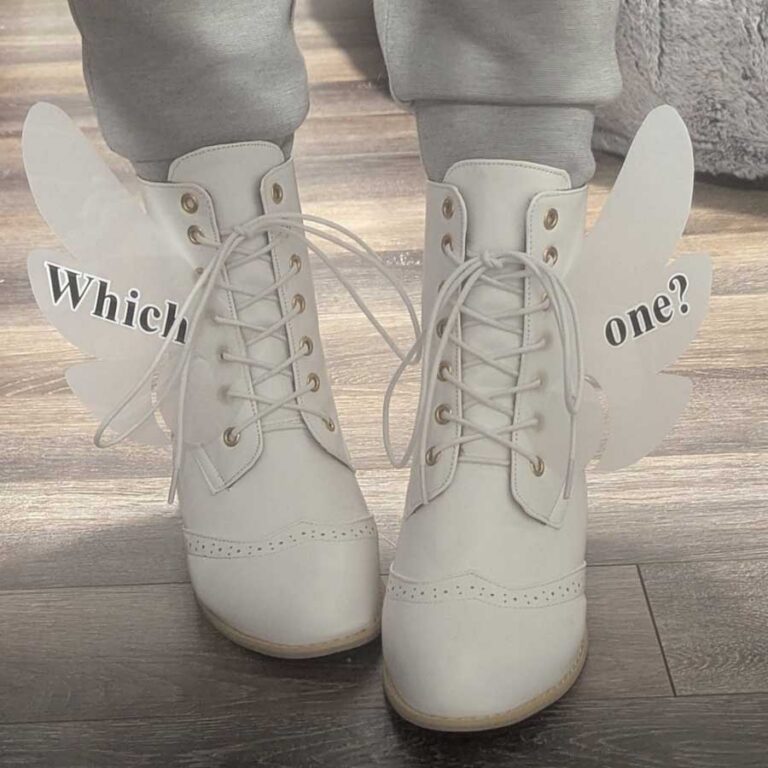White lace-up boots with translucent wing-shaped decals attached through the laces, flaring out on either side. They say "Which" and "one?" on each wing.