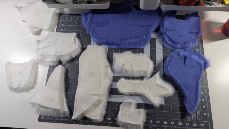 All the fur pieces cut from the masking tape pattern of the fursuit head, laid out and ready for sewing.