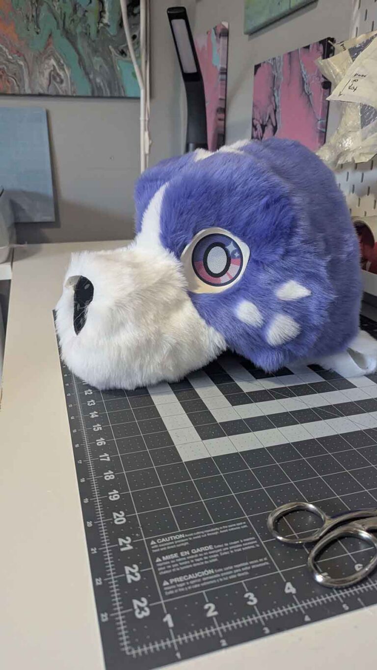 The fur pieces of the head layered over the 3d fursuit head base.
