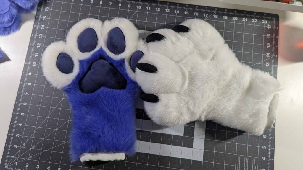The completed fursuit paws, with plush paw pads and soft claws.
