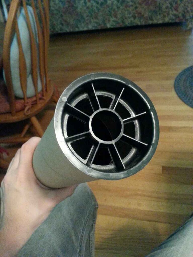 Poster tube, with a black plastic cap on the end that forms natural spacers for the arrows to sit in.